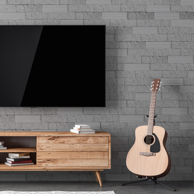Piatră decorativă gri pe un perete interior, living cu televizor și chitară